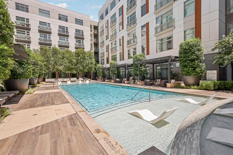 a swimming pool in the middle of a tall building