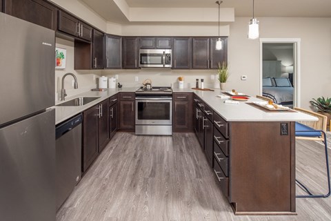 a large kitchen with wooden cabinets and stainless steel appliances