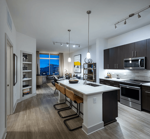 a kitchen and living room with a large white counter top