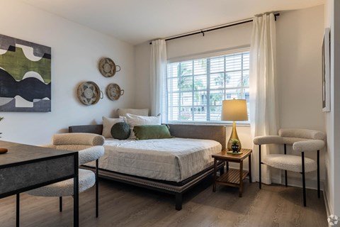 a bedroom with a bed and a window