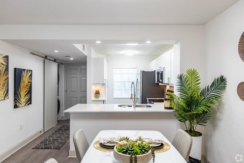 an open kitchen and dining room with a table and chairs