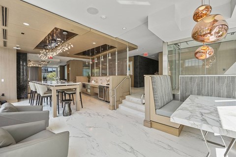 A modern living room with a grey sofa and a marble table.