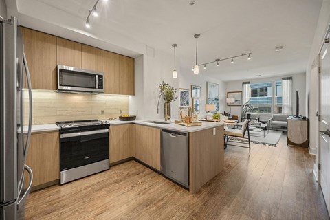 A modern kitchen with wooden cabinets and stainless steel appliances.