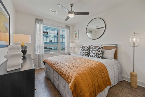 a bedroom with a bed and a ceiling fan