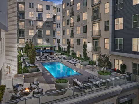 an apartment building with a swimming pool in the middle