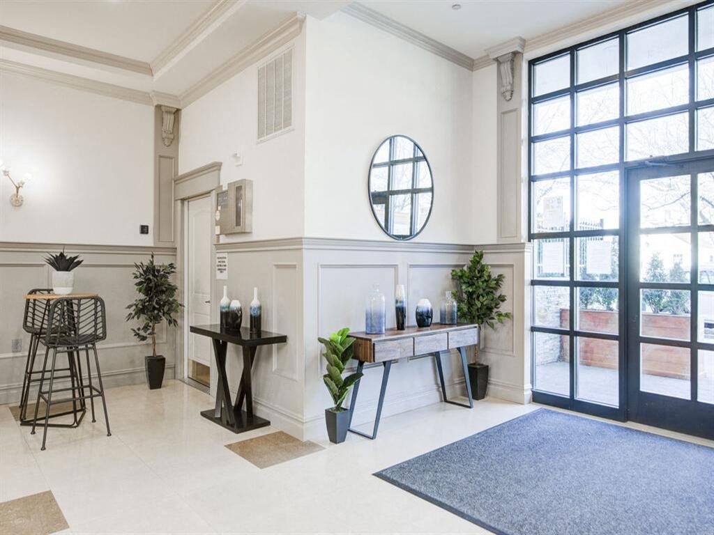 a living area with a table and chairs and a glass door
