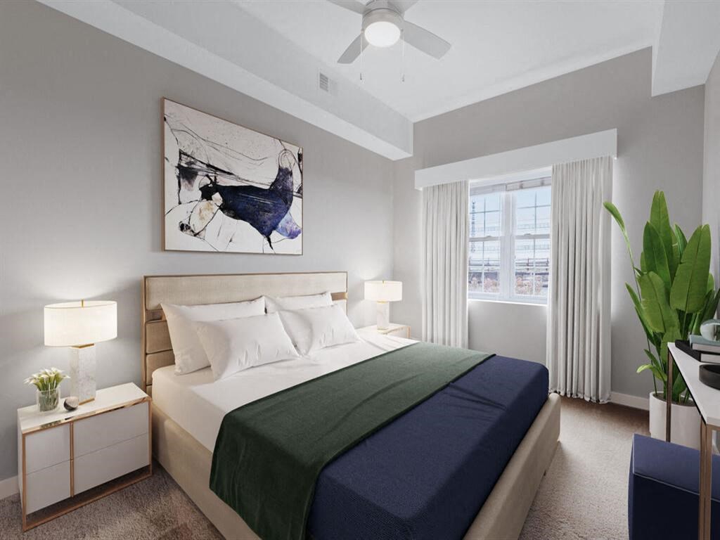 a bedroom with a bed and a ceiling fan