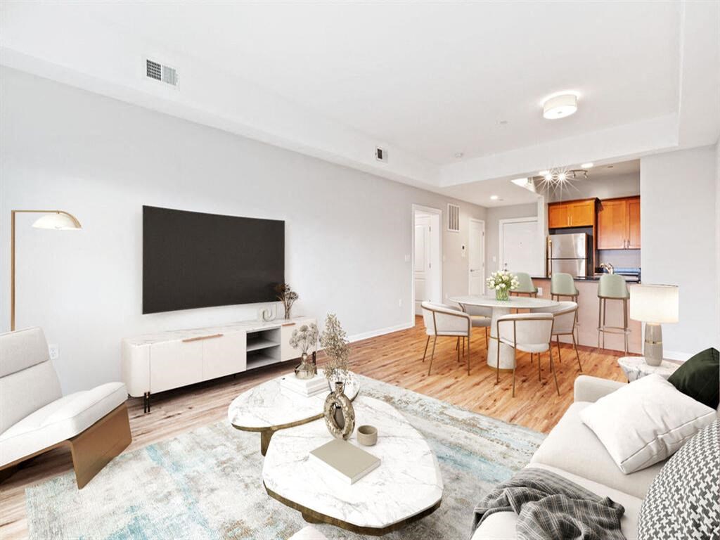 a living room with a couch and a tv in front of it