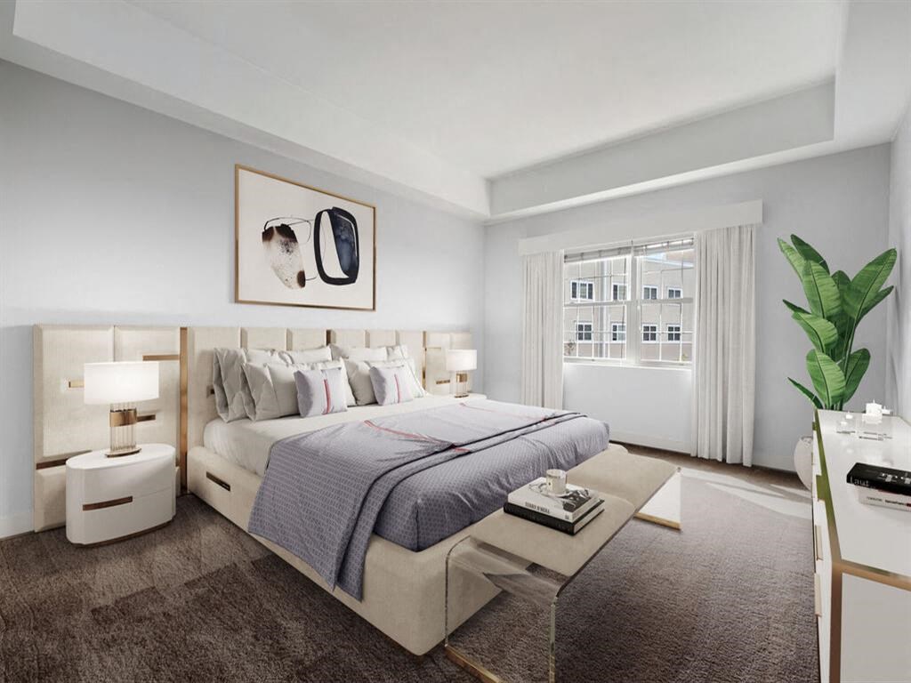 a bedroom with a large bed and a large window