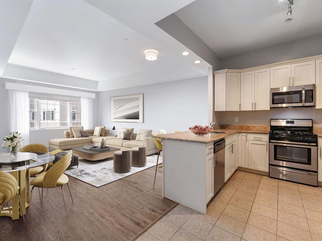 a kitchen and living room with a table and chairs