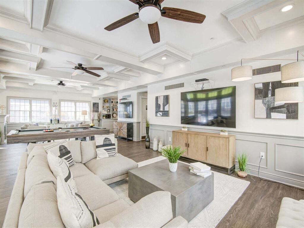 a living room filled with furniture and a flat screen tv