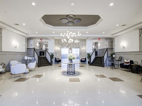 a lobby with a table and chairs and a chandelier