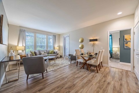 A living room with a grey sofa and wooden floors.