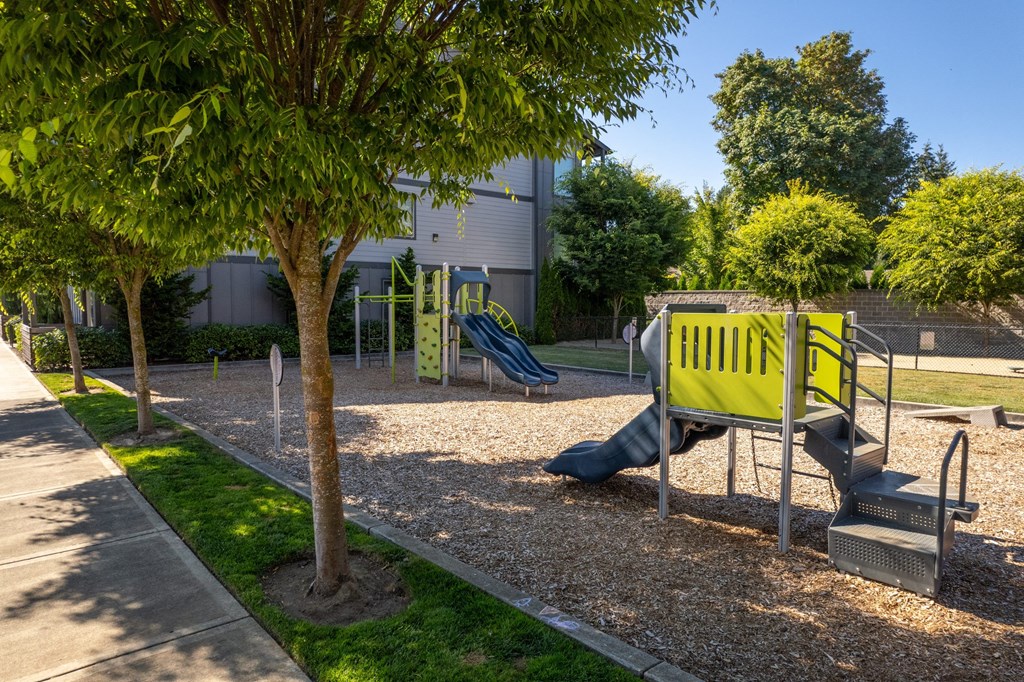 a playground with a yellow bench and a blue slide