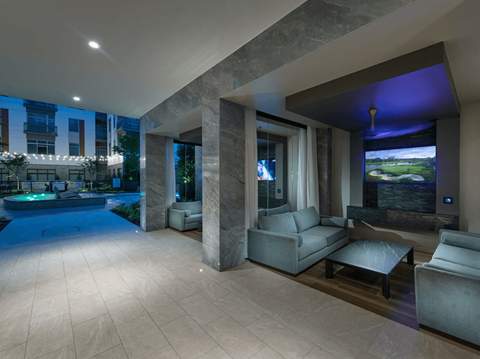 a large lobby with couches and a pool