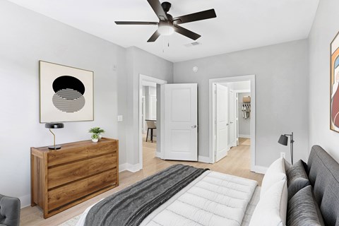 A modern living room with a grey couch and a wooden dresser.