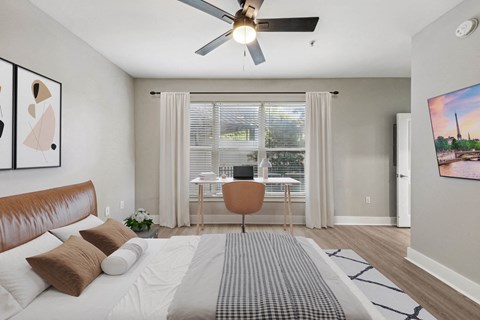 a bedroom with a bed and a ceiling fan