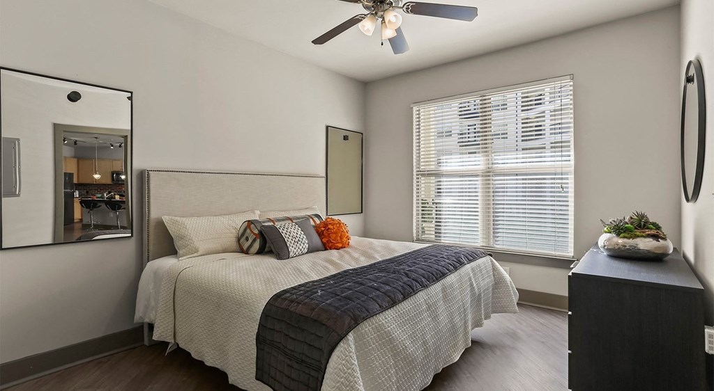 a bedroom with a bed and a ceiling fan