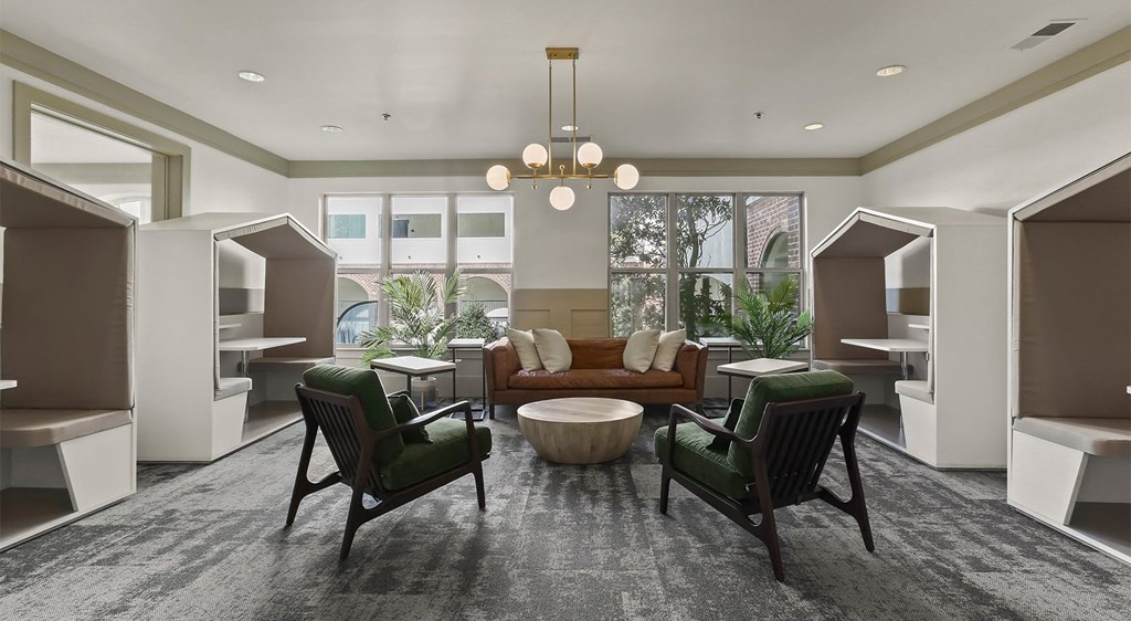 a lobby with a couch and chairs and a table