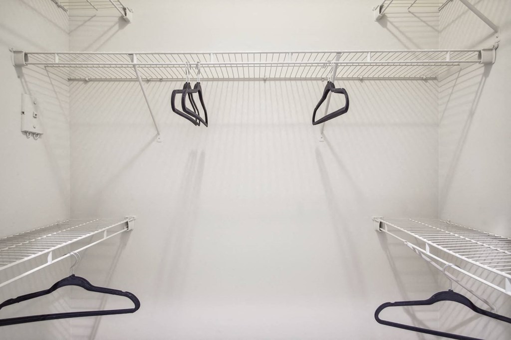 a walk in closet with empty shelves