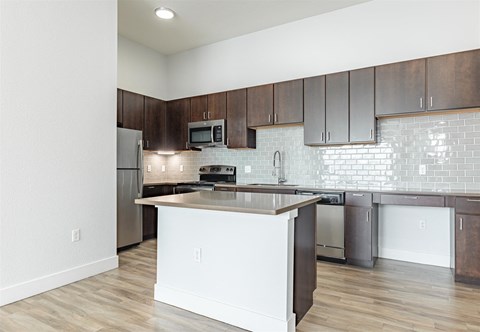a kitchen with an island and stainless steel appliances at RockVue, Broomfield, Colorado