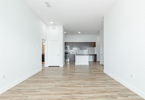 a spacious living room with a kitchen in the background at RockVue, Broomfield, CO