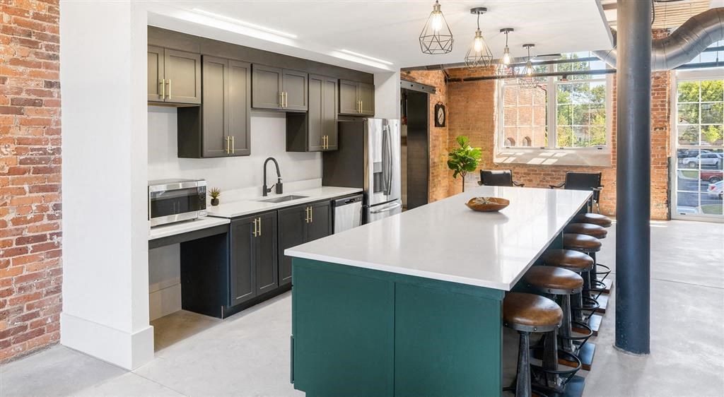 a kitchen with a large white counter top