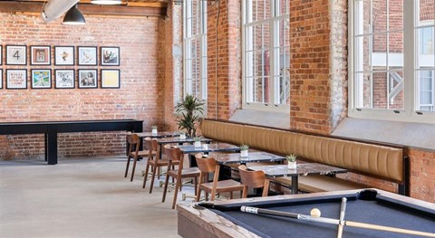 a restaurant with a pool table and tables