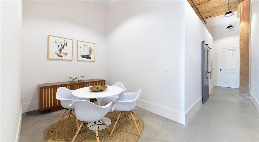 a dining room with a white table and chairs