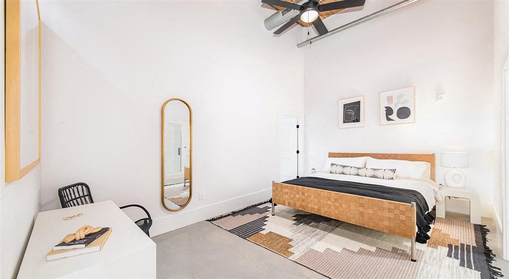 a bedroom with a bed and a ceiling fan