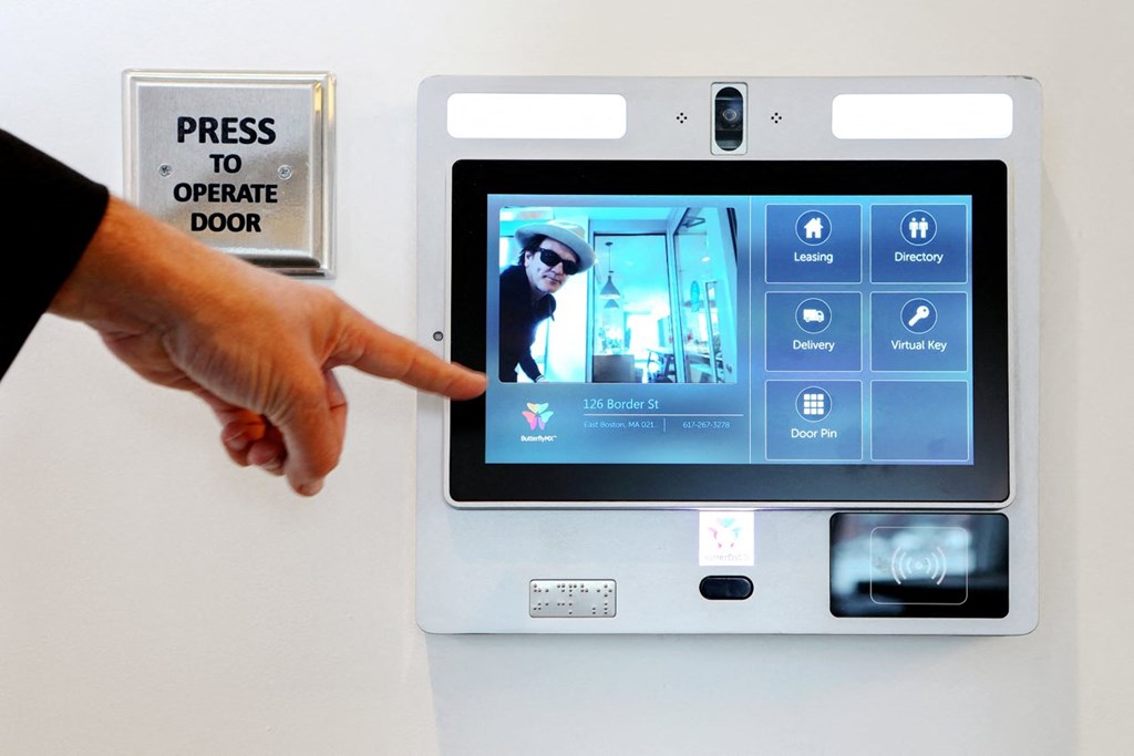 a hand is pointing to the screen of a tablet computer