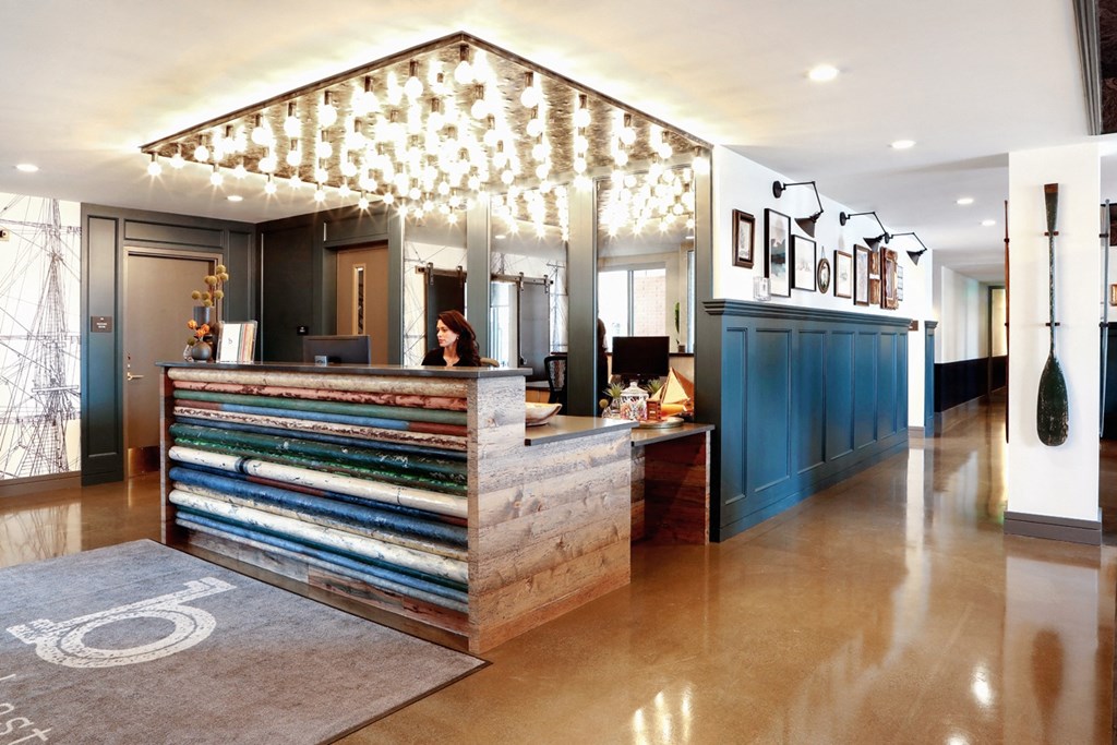 a lobby with a reception desk and a light fixture