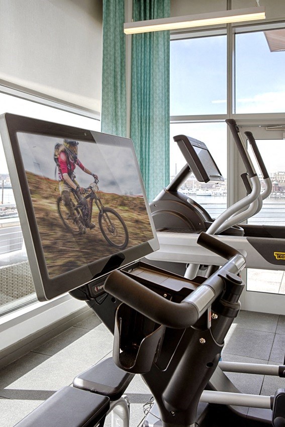 a person riding a bike on a monitor on a treadmill