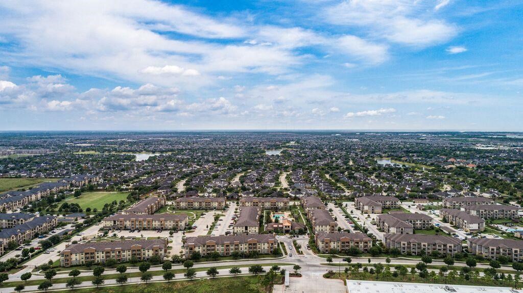 an aerial view of a large city with houses and trees