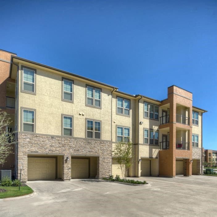 a large brick building with a parking lot in front of it