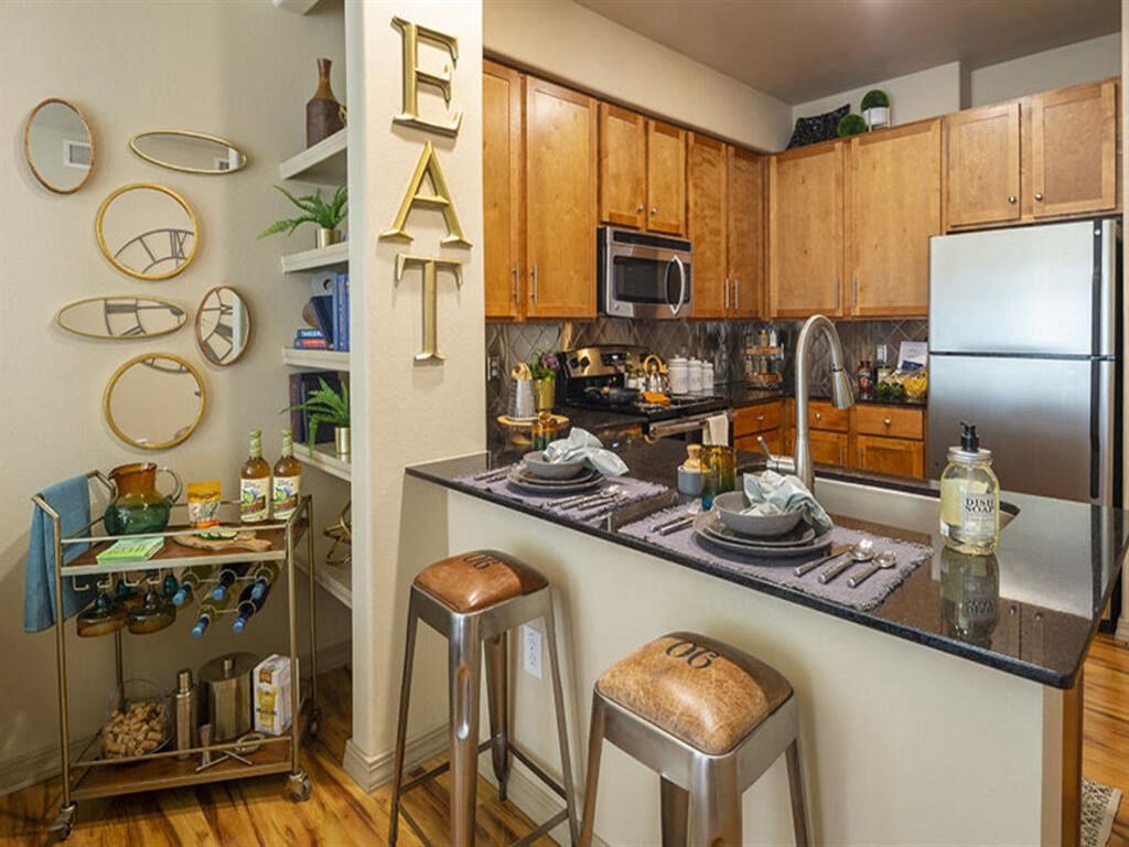 a kitchen with a counter top and stools