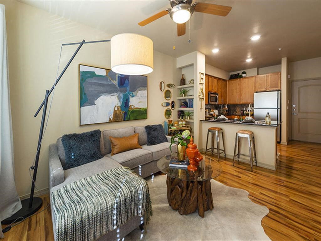 a living room filled with furniture and a ceiling fan