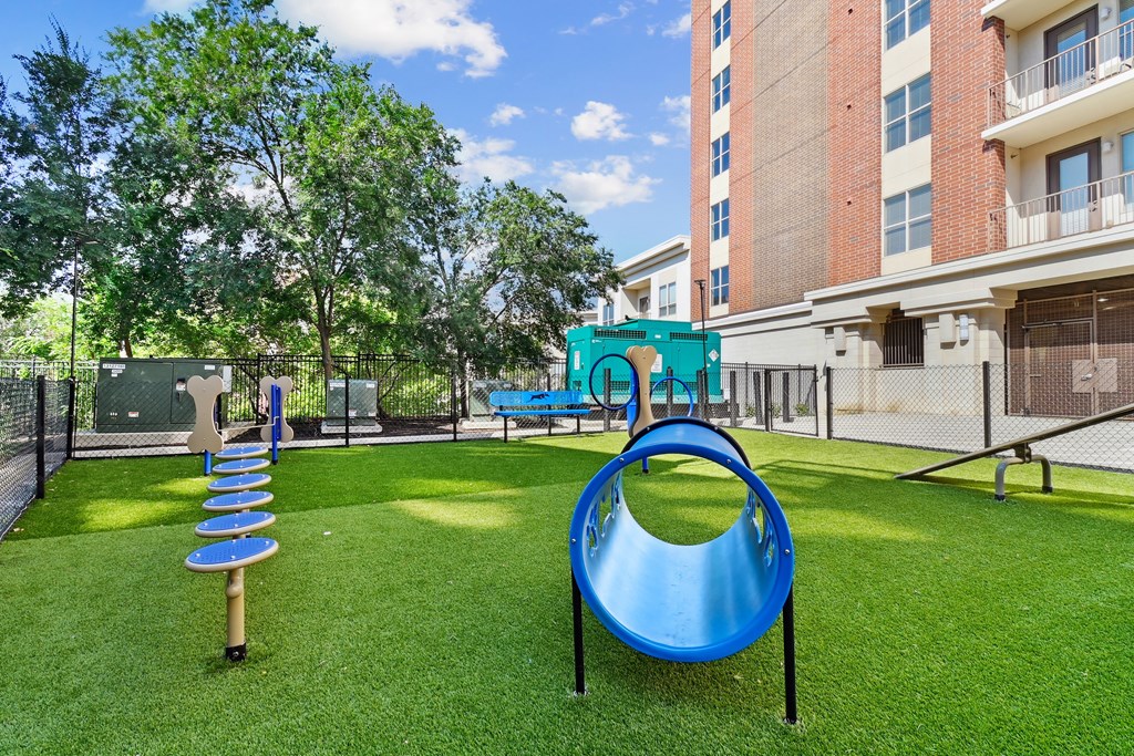 A playground with a blue slide and a green play structure.
