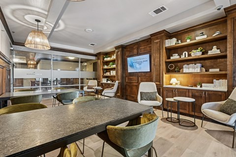 A modern dining room with a large table and chairs.