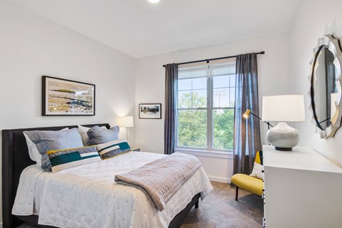 a bedroom with a bed and a window