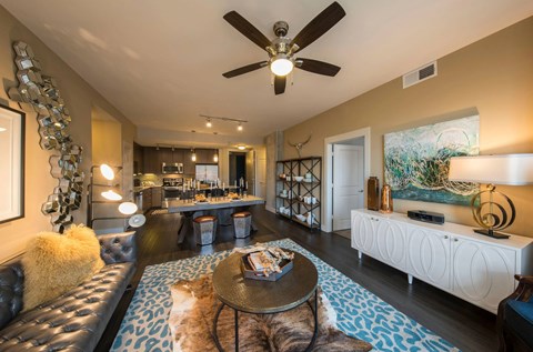 A modern living room with a leather couch and a coffee table.