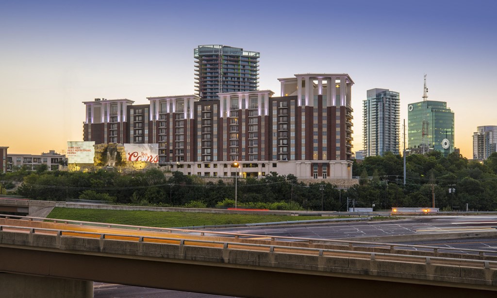 A large building with a lot of windows is in the background.