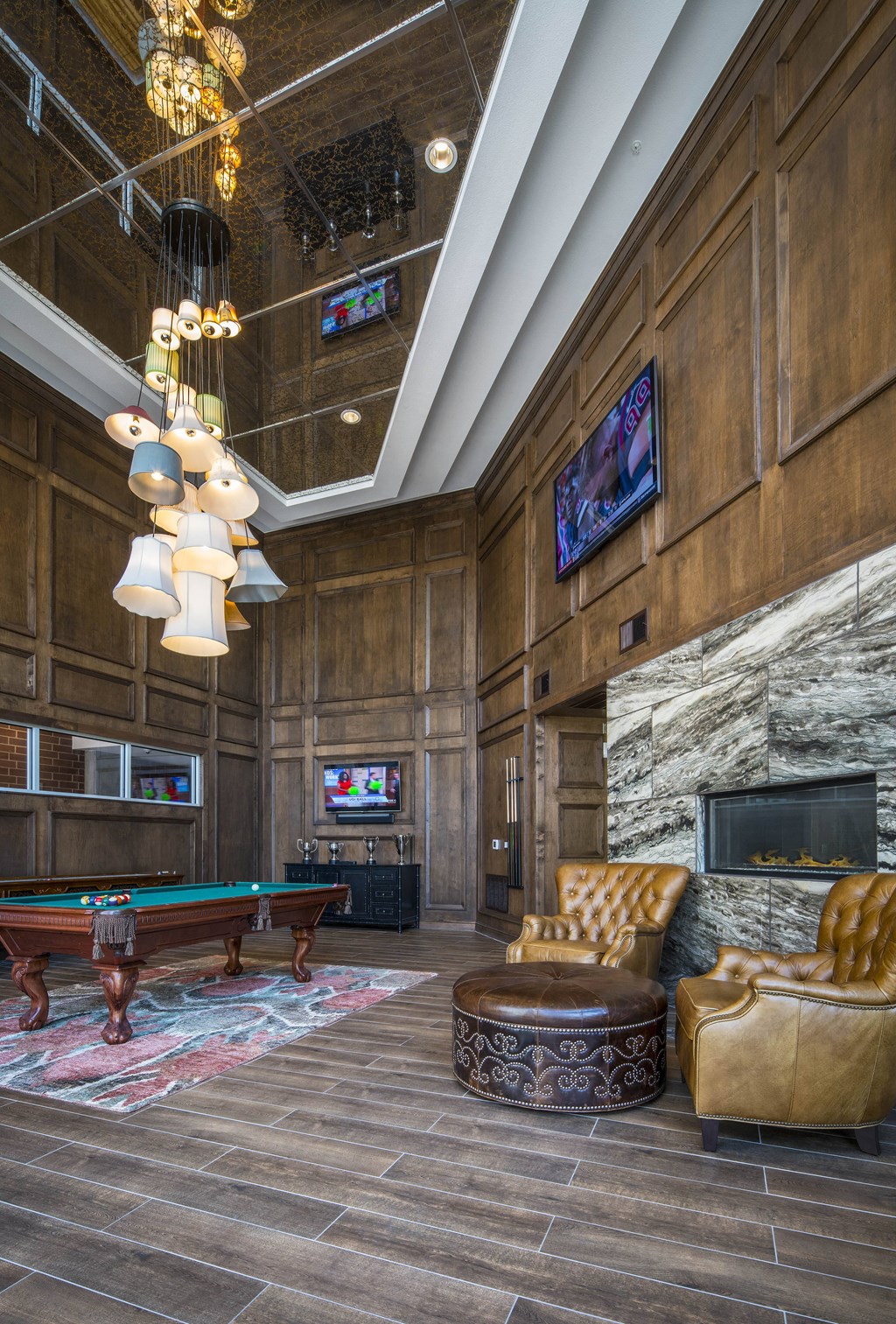 A room with a pool table and a fireplace.