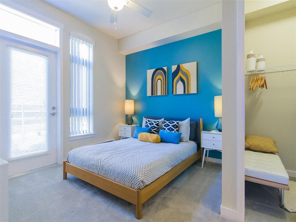a bedroom with a bed and a blue wall