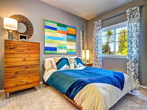 a bedroom with a bed and a dresser