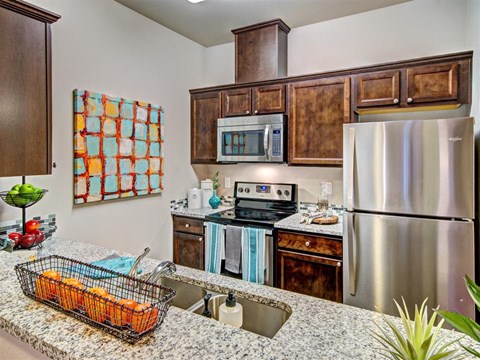 a kitchen with stainless steel appliances and granite counter tops