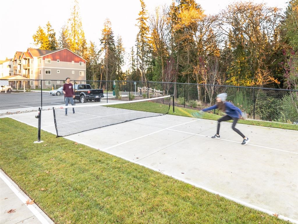 two people playing tennis on a tennis court