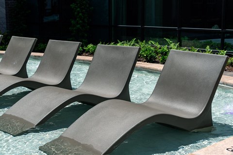 a group of chairs sitting in a pool