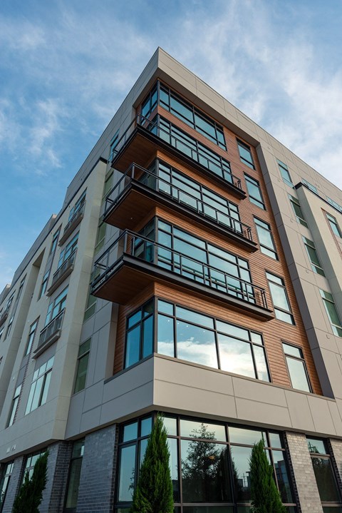 a tall building with balconies and a blue sky