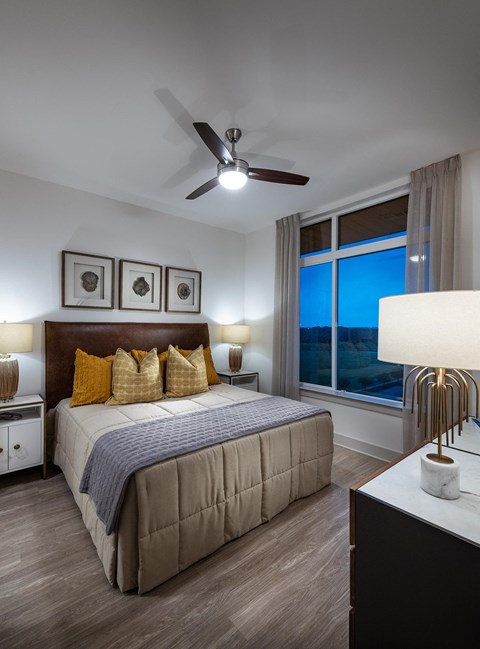 a bedroom with a large bed and a ceiling fan